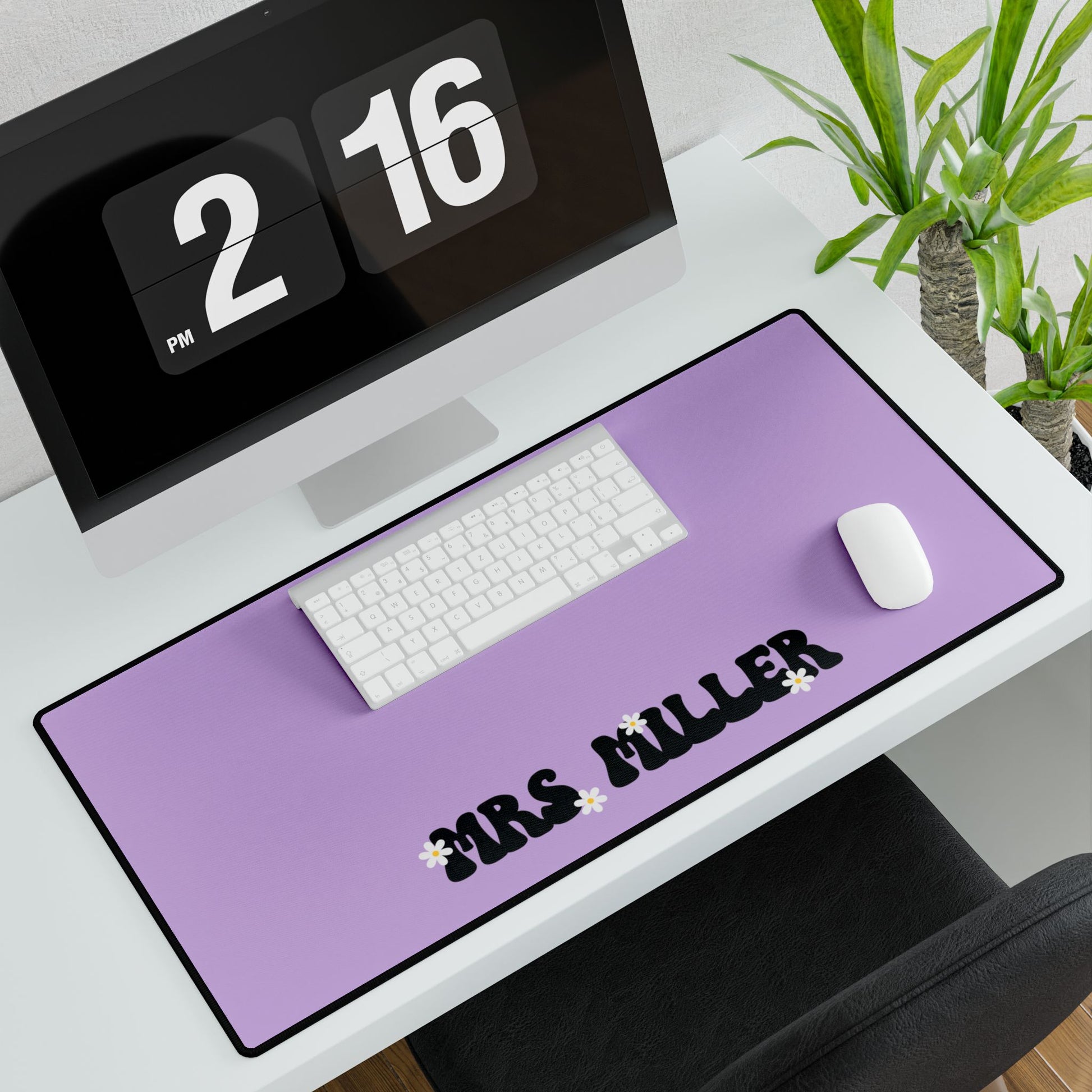 Purple desk mat with 'MRS MILLER' printed on it, placed on a desk with a computer and mouse.